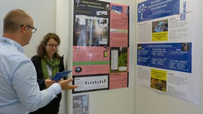 Nathalie discussing her research with an interested visitor of the poster session reduced